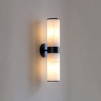 The Clérachic Sway in its black finish, twin alabaster cylinders glowing above and below a matte black band.