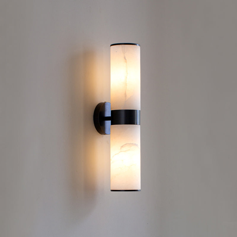 The Clérachic Sway in black, the stone shades casting a gentle amber glow across a pale grey wall.