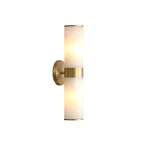Clérachic Sway sconce on a clean white studio backdrop, showing the brushed brass collar and alabaster tubes.