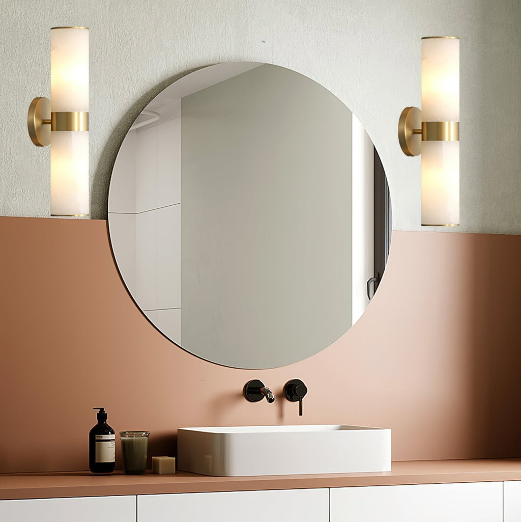 The Clérachic Sway mounted as a pair either side of a round vanity mirror above a terracotta washstand.