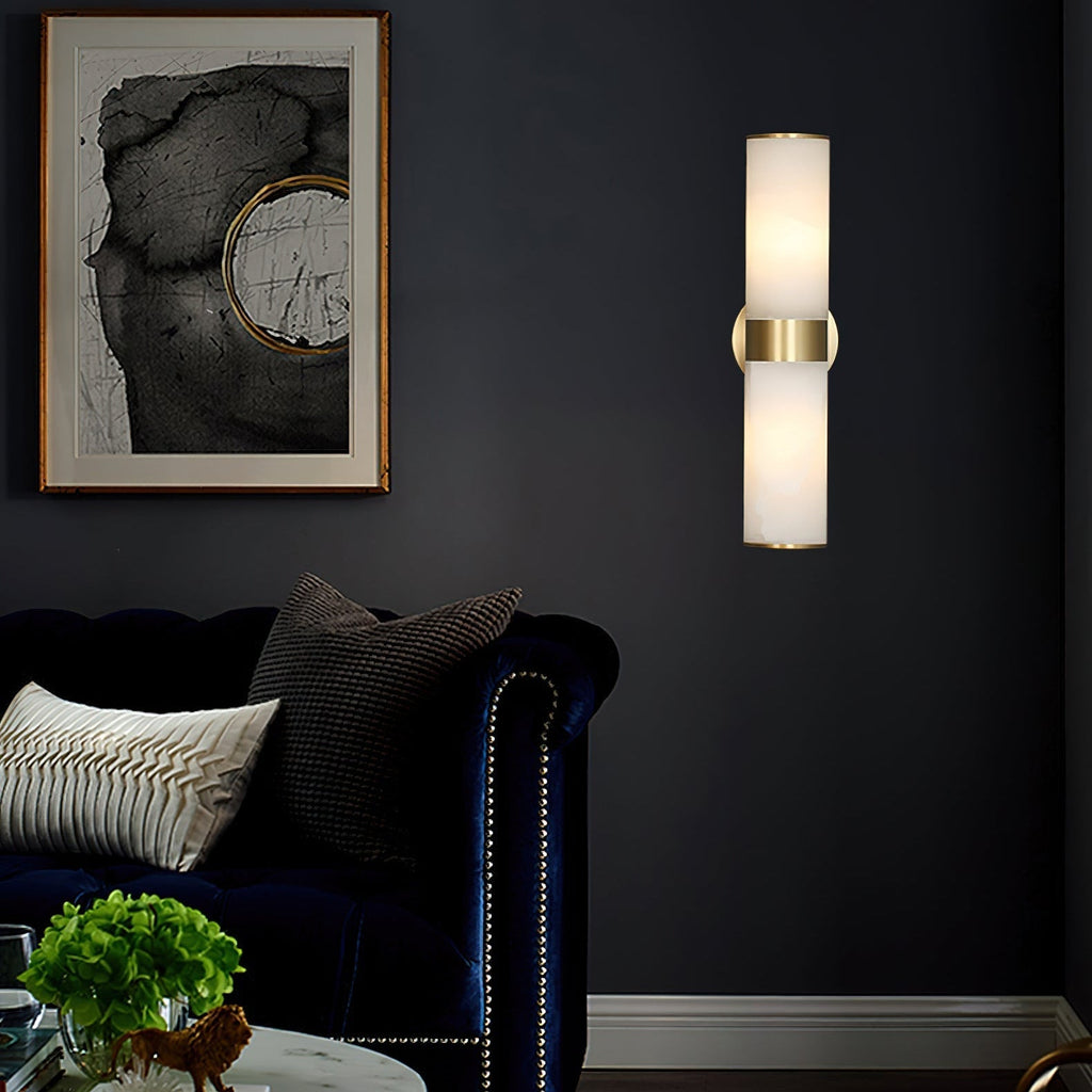 Clérachic Sway lighting a deep navy living room wall beside a framed abstract print and a velvet sofa.