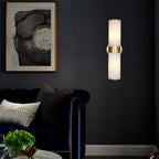 Clérachic Sway lighting a deep navy living room wall beside a framed abstract print and a velvet sofa.
