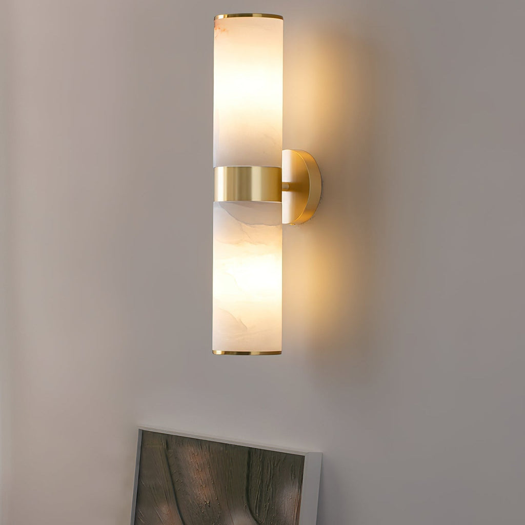 Clérachic Sway close up, warm light pooling on the wall above and below the brushed brass centre band.