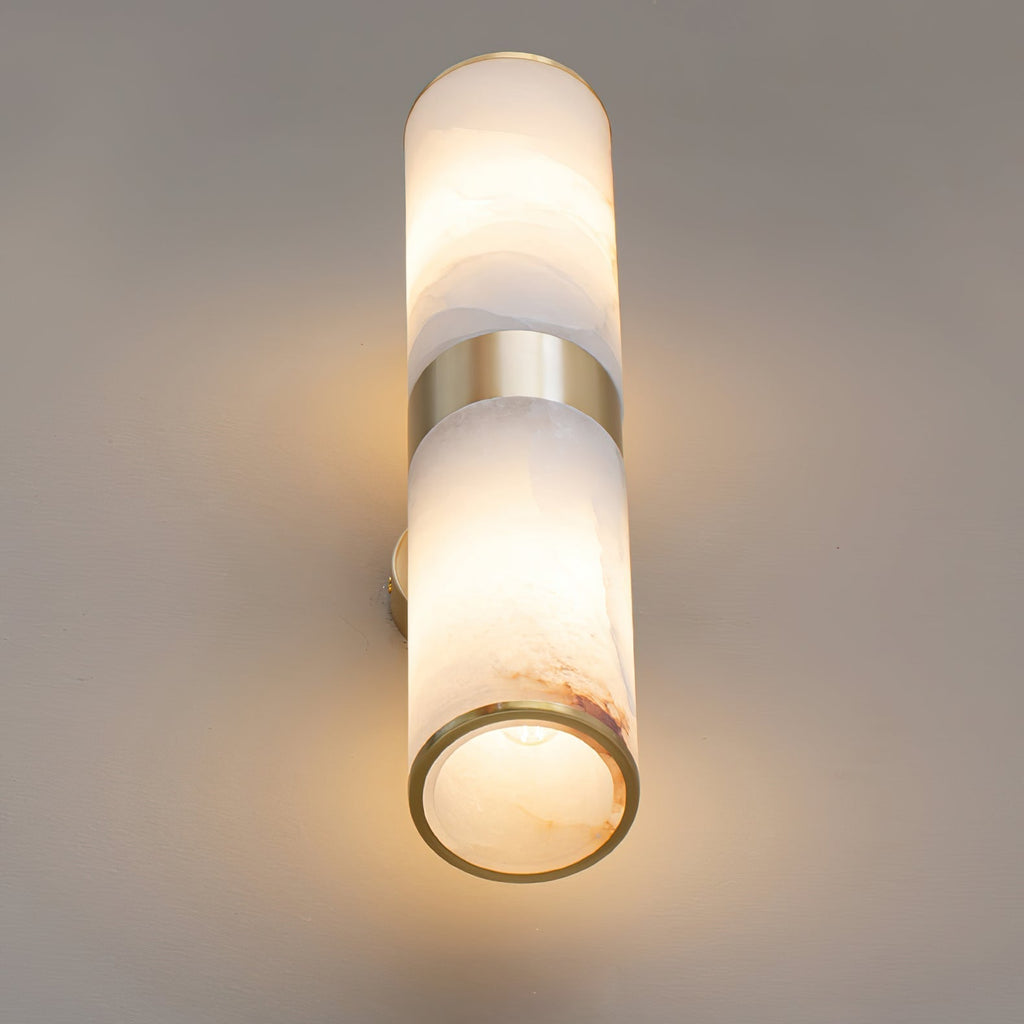 Clérachic Sway seen from below, the open brass rim revealing warm light inside the alabaster tube.