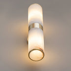Clérachic Sway seen from below, the open brass rim revealing warm light inside the alabaster tube.