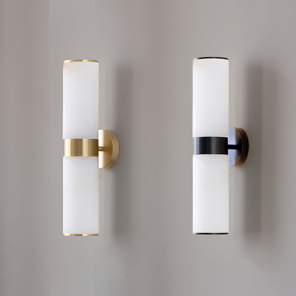 The Clérachic Sway in brass and in black, mounted side by side and unlit for a direct finish comparison.