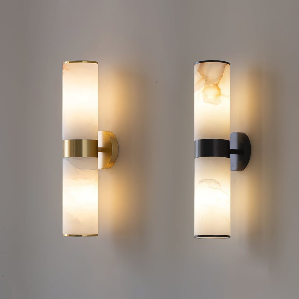 Clérachic Sway shown lit in both finishes, brass on the left and black on the right, on a grey wall.