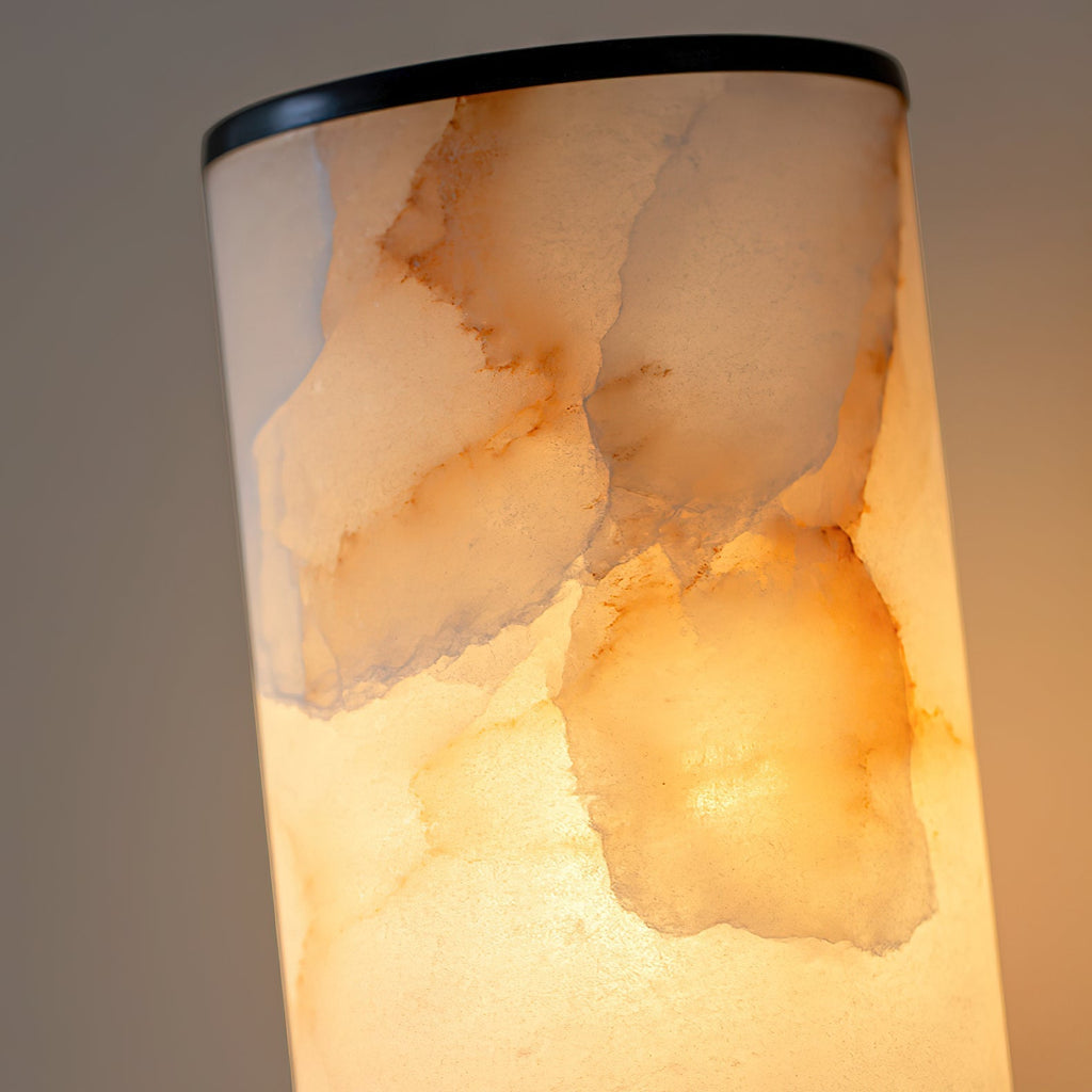 Clérachic alabaster shade in macro, backlit so amber and rust veining glows through the natural stone.