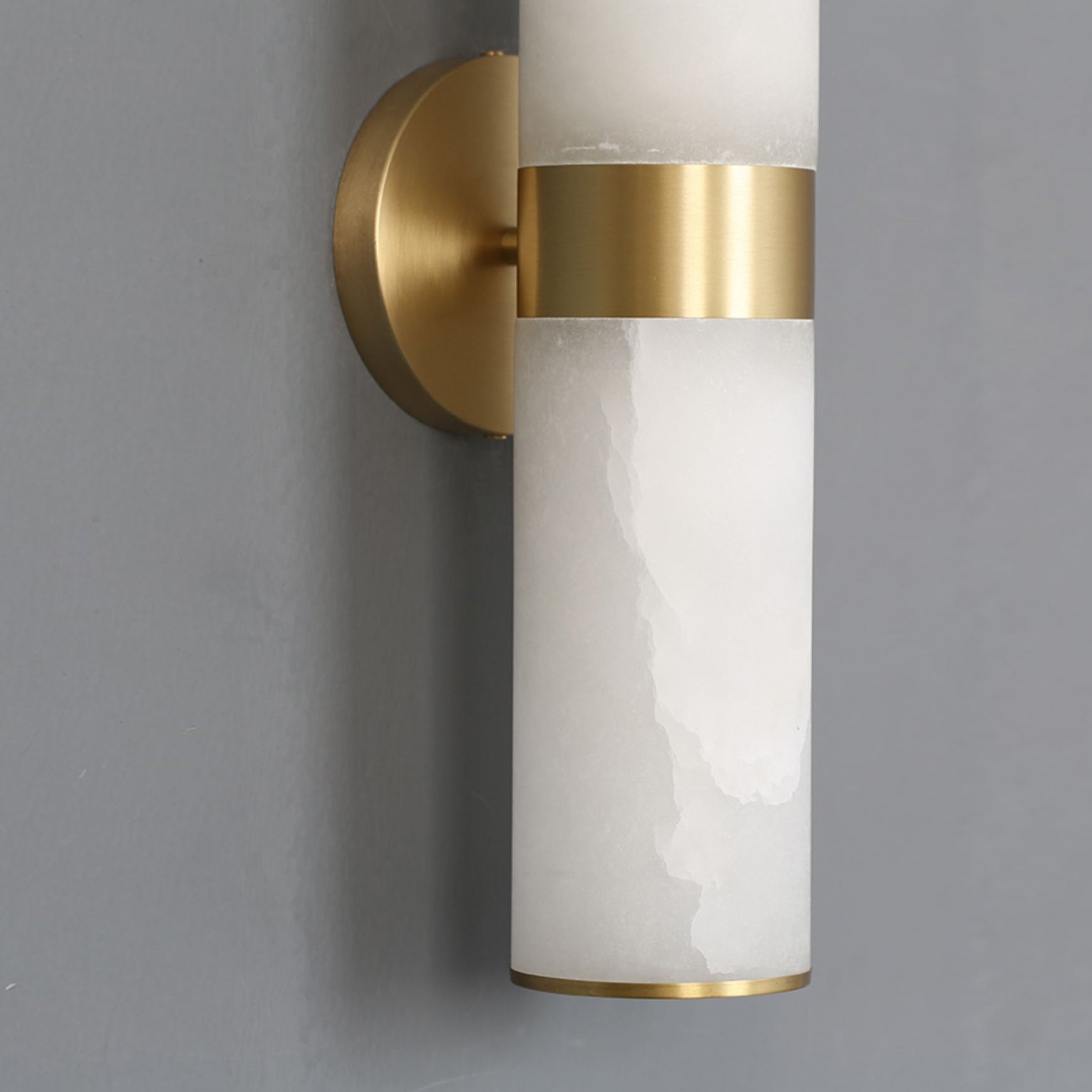 The Clérachic Sway detailed at the wall, round brass backplate and stem meeting the polished collar.