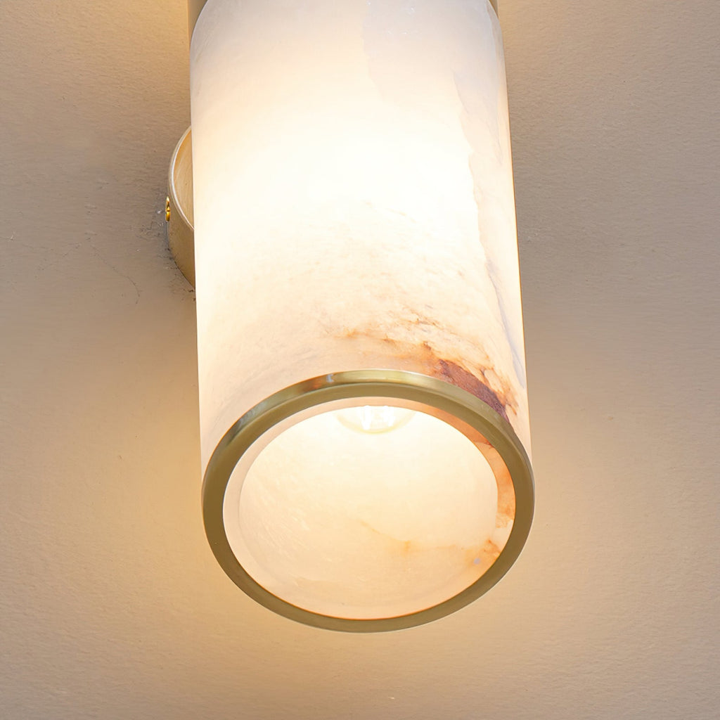 The Clérachic Sway viewed from underneath, brass ring open to show the bulb inside the stone shade.