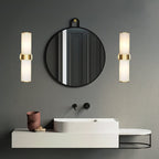 Clérachic Sway fitted in pairs either side of a round black mirror on a deep green bathroom wall.