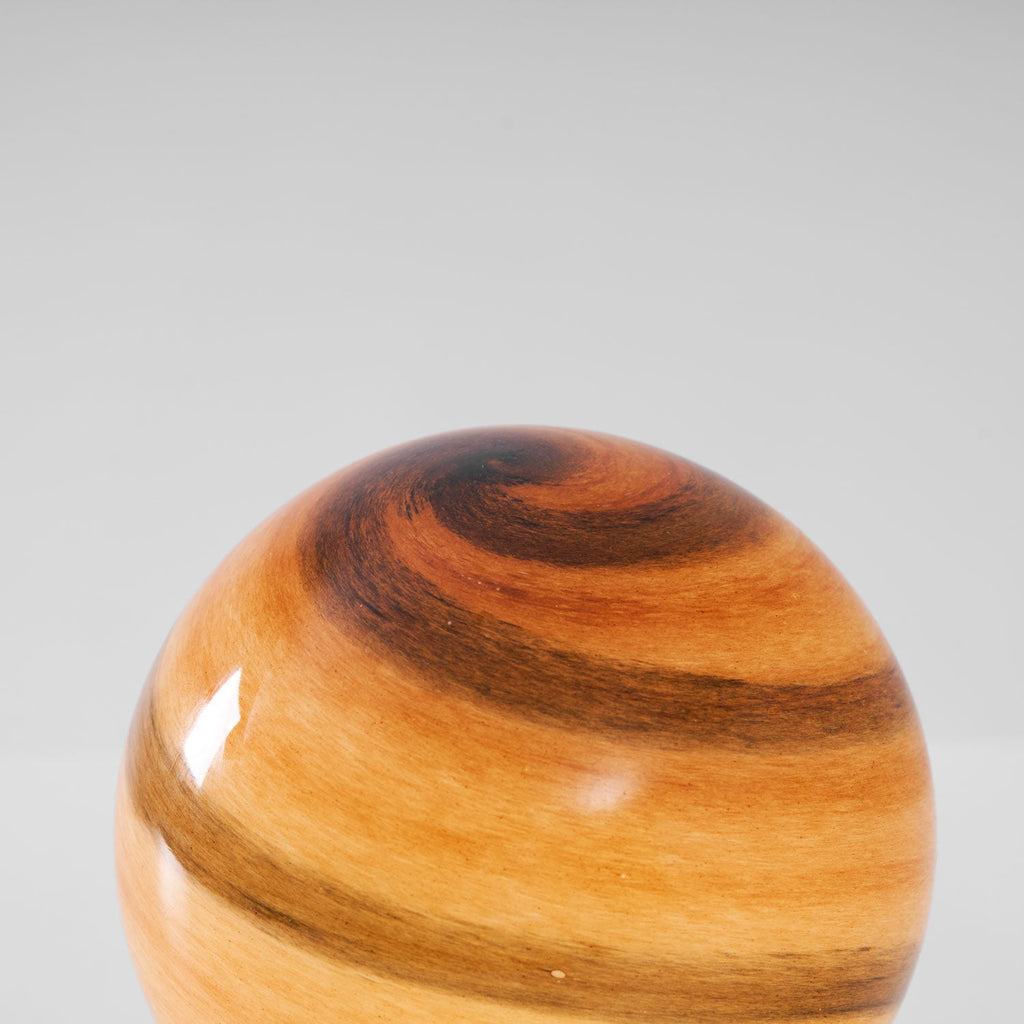 Close view of the swirled amber and brown banding in the glass globe of this Clérachic table lamp.