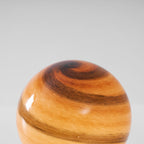 Close view of the swirled amber and brown banding in the glass globe of this Clérachic table lamp.