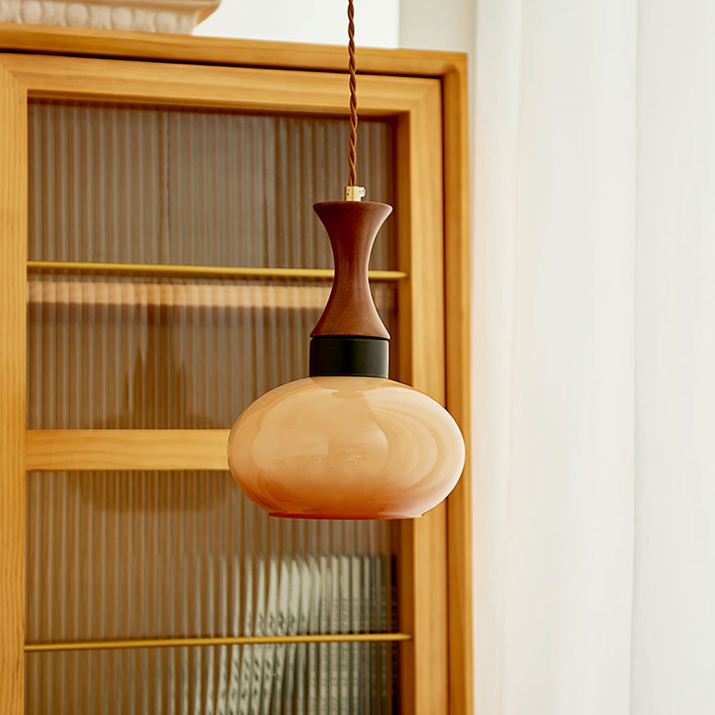 Clérachic Swirled Amber Glass Pendant Light in its small unlit shade, a soft caramel against a fluted cabinet in daylight.