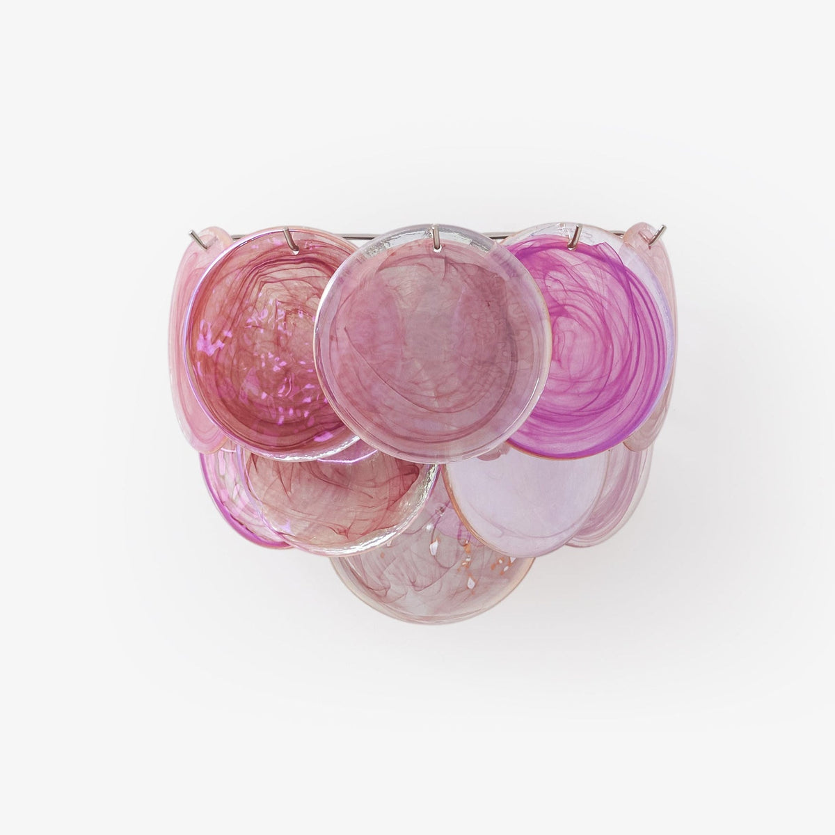 Pink glass-disc wall light from Clérachic on a plain white backdrop, its overlapping swirled discs in magenta and pale blush.