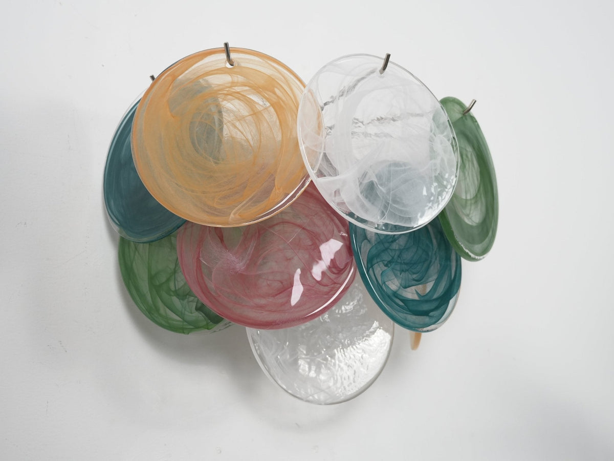 Straight-on view of an unlit multicolour glass-disc wall light from Clérachic with orange, white, teal, rose and green swirled discs.