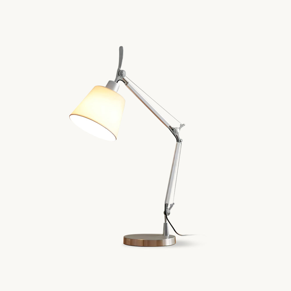 Silver swivel-arm table lamp from Clérachic with a white fabric shade, shown lit on a plain off-white backdrop.