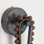 Detail of the Clérachic Sytala round black backplate, its fixing screws and walnut bead trim.