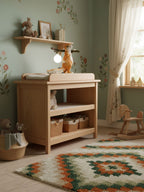 Clérachic squirrel lamp on a shelf above a wooden changing table in a nursery with sage walls and a patterned rug.