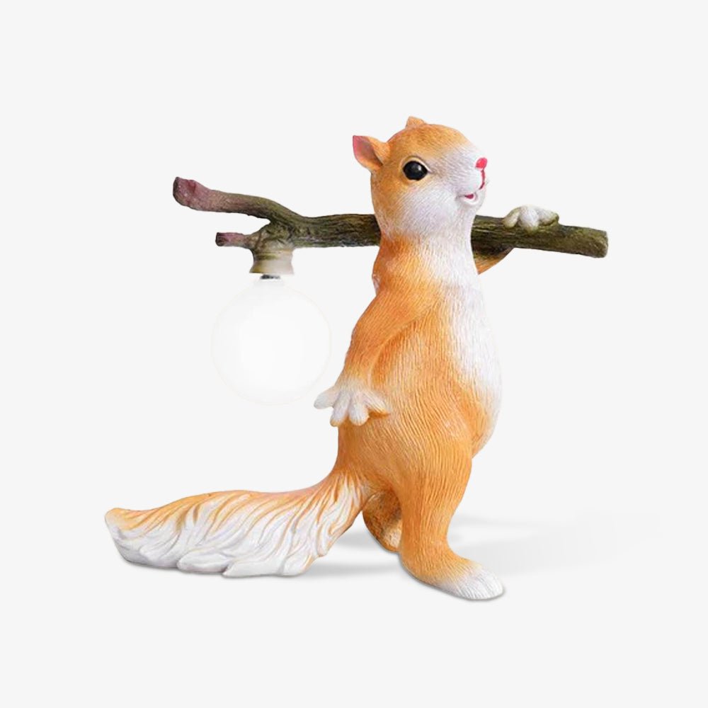 The Clérachic squirrel table lamp in orange and white with its round bulb off, shown on a plain white backdrop.