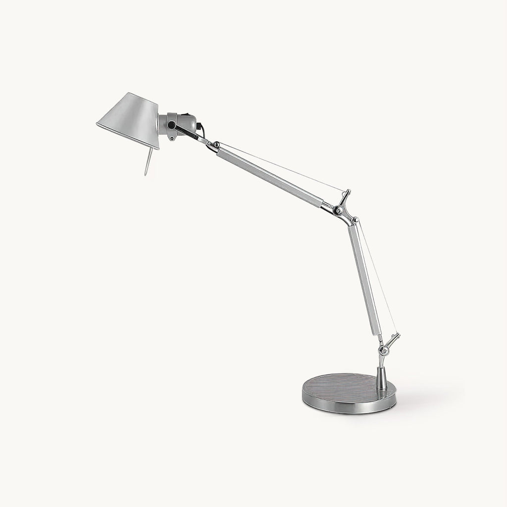 This Clérachic chrome desk lamp on a plain white backdrop, with a jointed arm, a conical shade and a round base.