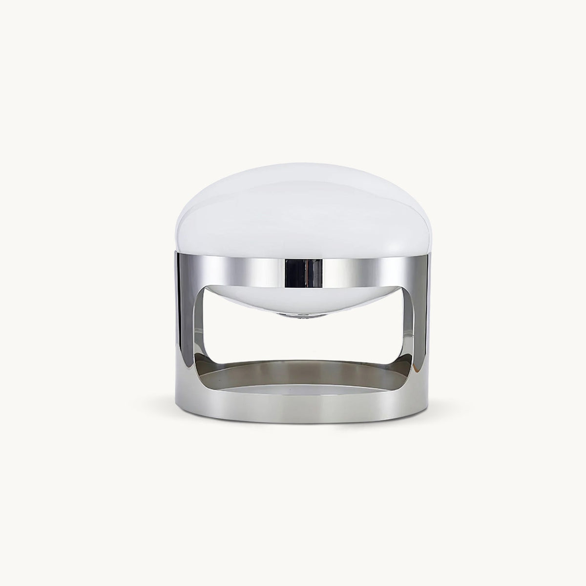 A Clérachic table lamp with a domed opal white shade and a polished chrome band with curved cutouts, on a plain white backdrop.