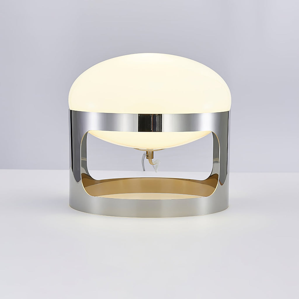 Front view of the Clérachic table lamp on a pale grey surface, showing the opal dome, the chrome band and the open lower section.