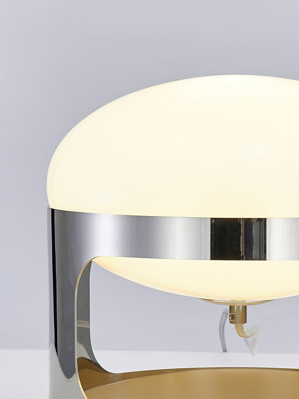 Close view of the opal dome and the polished chrome band on this Clérachic table lamp, with the small stem and cord visible inside.