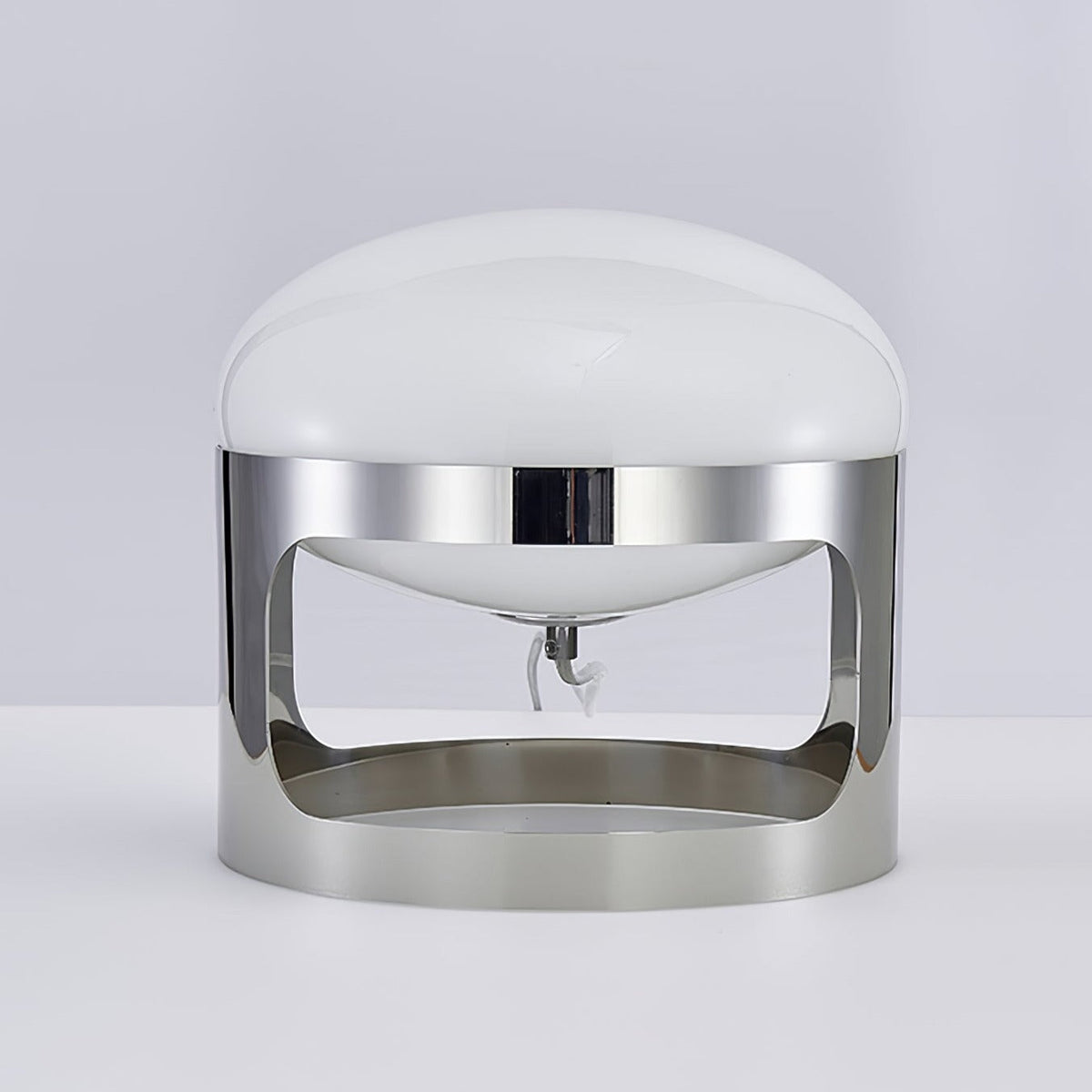Unlit Clérachic table lamp with a white opal dome and a mirror-polished chrome band, on a pale grey backdrop.