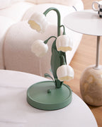 A Clérachic table lamp on a white marble tray table seen from above, with a cream sofa and a round side table beside it.