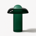 Clérachic green glass table lamp with a wide dark shade like a mushroom cap, a tall cylinder body and a pale dome on top.