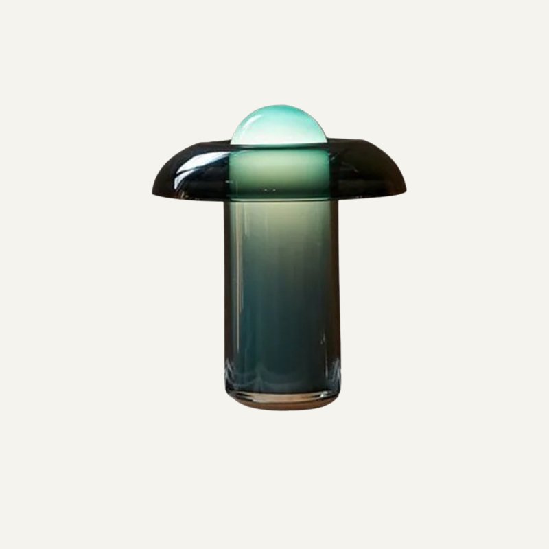 Clérachic green glass table lamp with a smoky dark brim and a glowing green dome, on a plain off-white background.