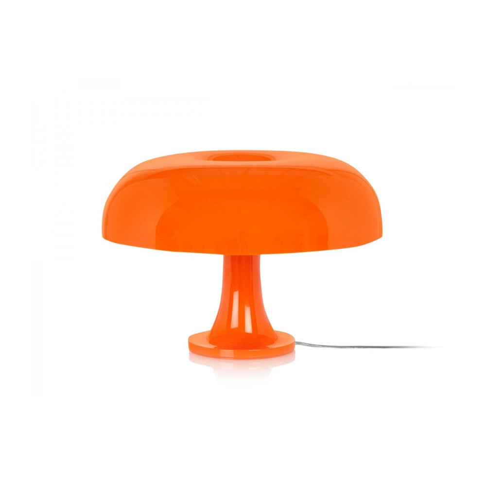 Orange Clérachic table lamp on a plain white background, its cord trailing out to the right.