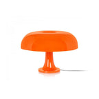 Orange Clérachic table lamp on a plain white background, its cord trailing out to the right.