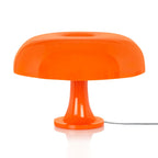Front view of this Clérachic orange mushroom lamp on a white background, the shade glossy and the stem flaring to the base.