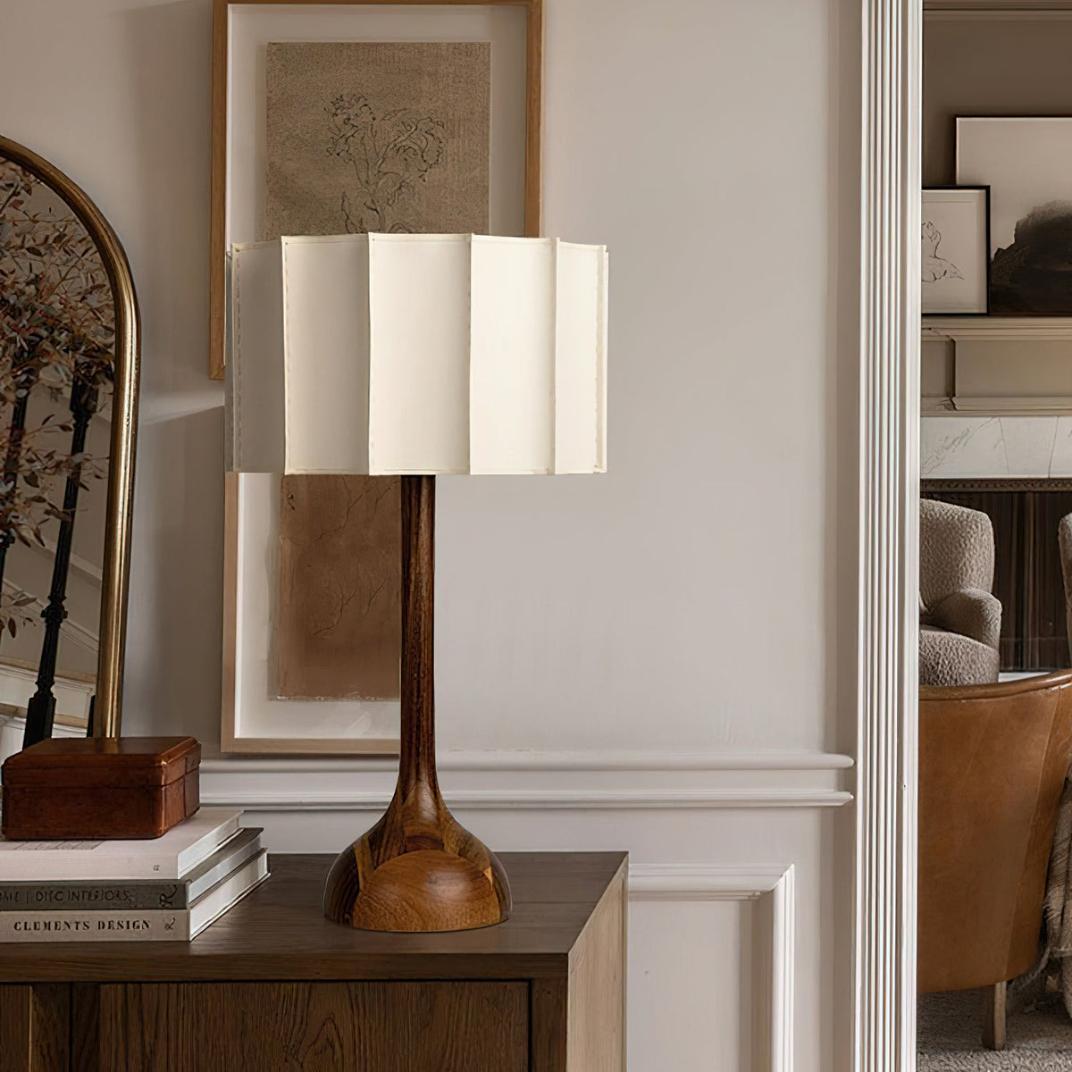 Clérachic table lamp on a dark cabinet in a panelled hallway, with a mirror and framed sketch behind.