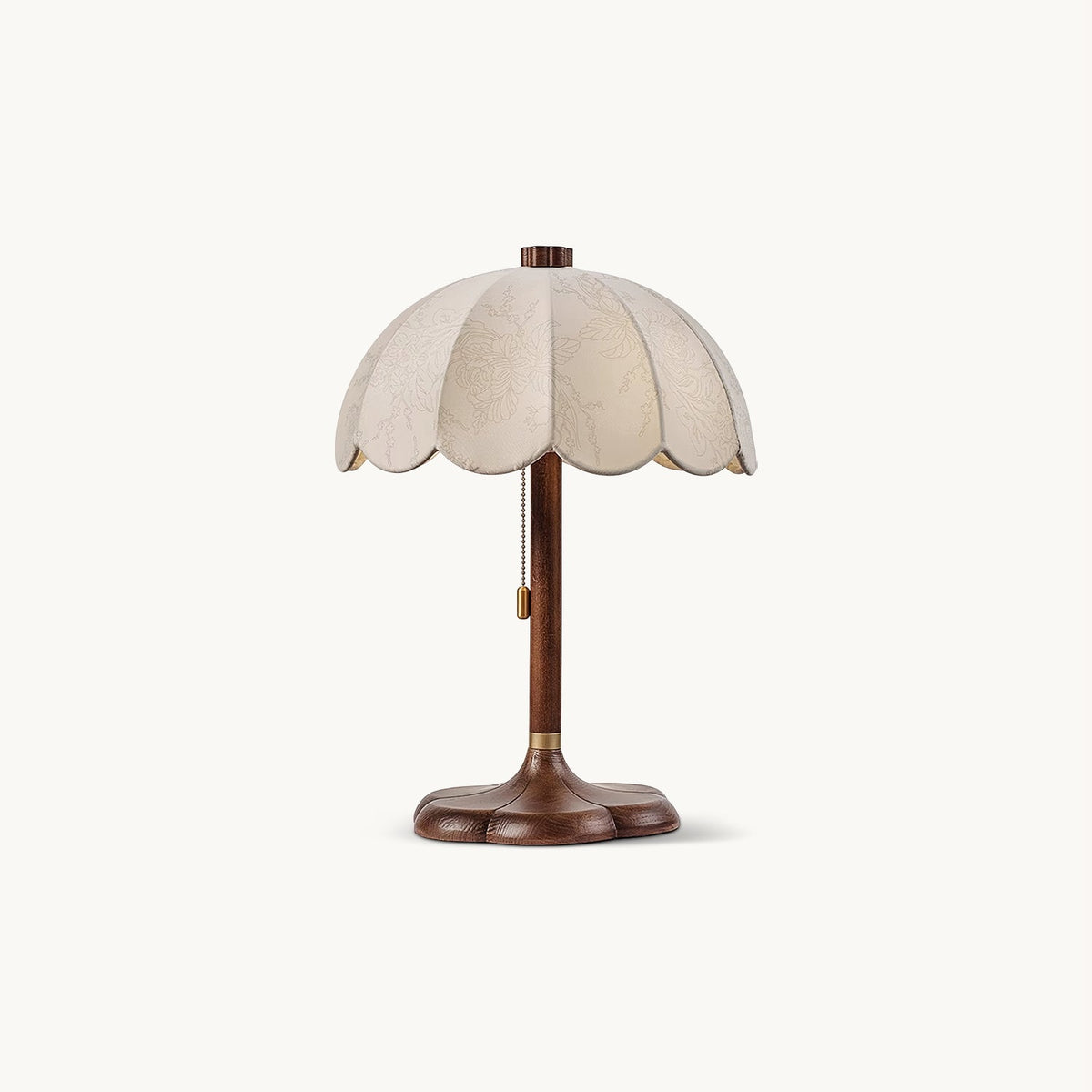Clérachic table lamp with a scalloped beige fabric shade and a walnut-coloured stem on a clover-shaped base, on a plain white backdrop.