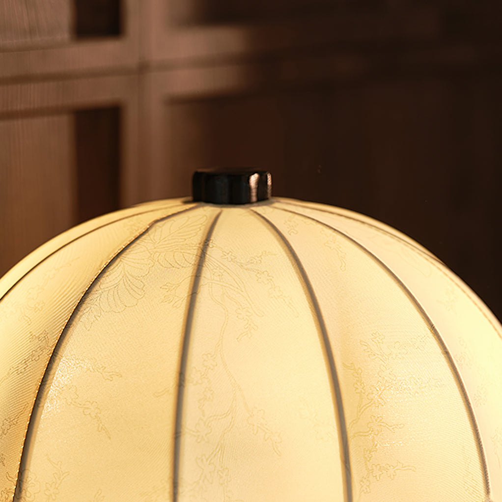 Close view of the ribbed, softly lit fabric shade and dark finial on this Clérachic table lamp.