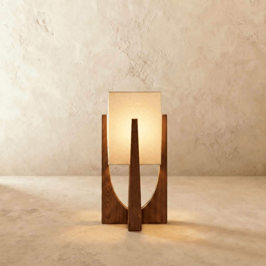 Clérachic table lamp in dark walnut with a tapered wooden frame and a lit rectangular linen shade, on limewash.