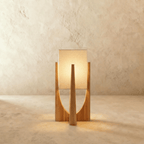 Clérachic table lamp in light natural wood with a tapered frame and a softly glowing rectangular fabric shade.
