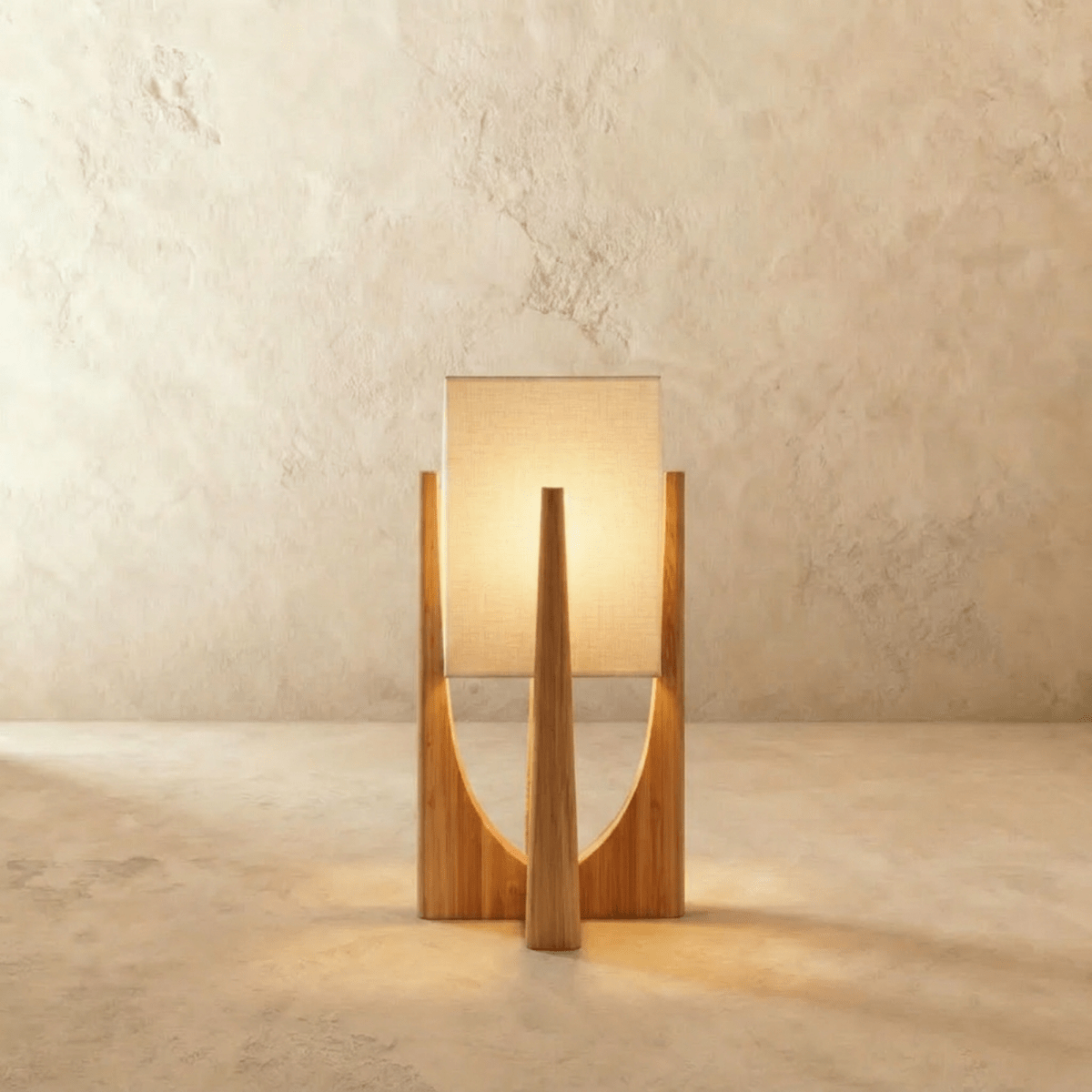 Clérachic table lamp in light natural wood with a tapered frame and a softly glowing rectangular fabric shade.