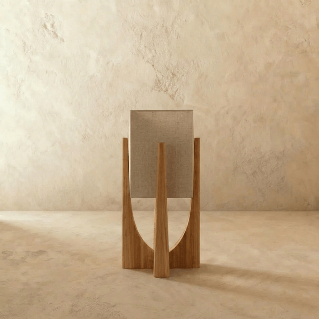 Rear view of the Clérachic table lamp in light wood, showing the woven linen shade and the curved frame legs.