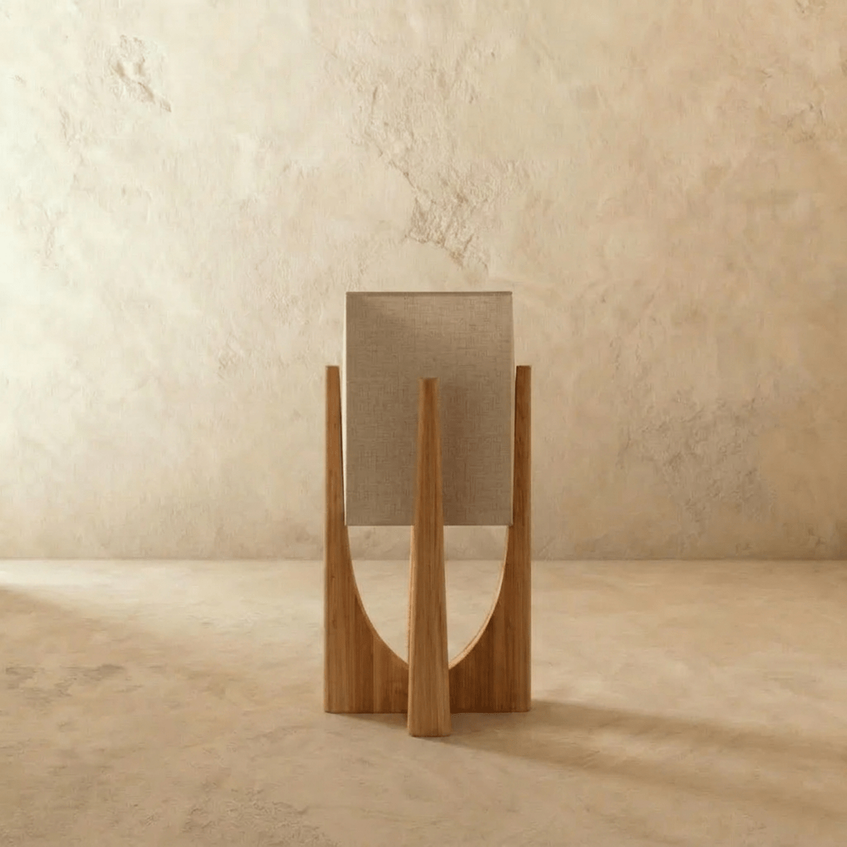 Rear view of the Clérachic table lamp in light wood, showing the woven linen shade and the curved frame legs.