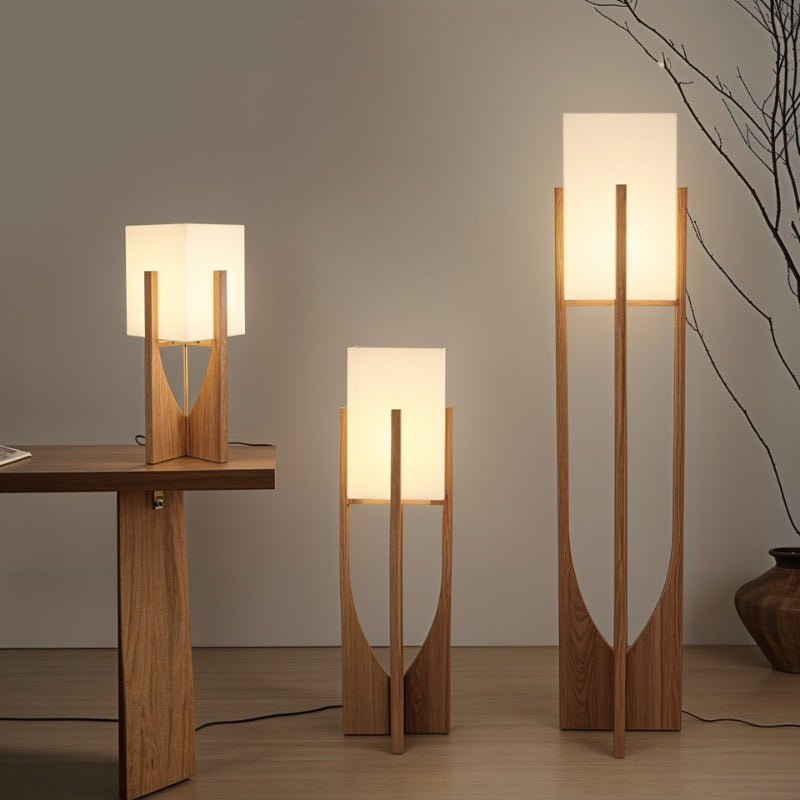 Clérachic wooden-framed lamps with white rectangular shades in three heights, lit against a grey wall.