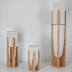 Clérachic light-wood lamps with textured stone-coloured shades in three heights on a plain pale background.