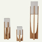 Clérachic light-wood lamps with stone-textured shades in three sizes, standing on a plain off-white ground.