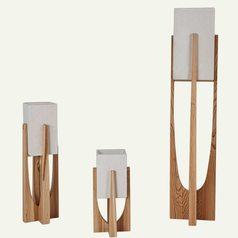 Clérachic light-wood lamps with stone-textured shades in three sizes, standing on a plain off-white ground.