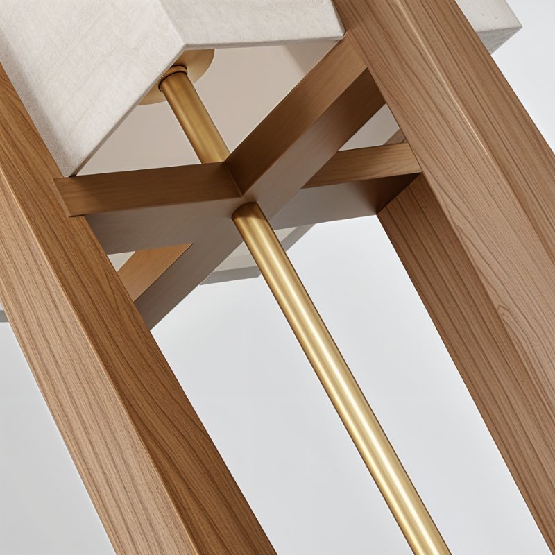 Close view of a Clérachic wooden lamp frame with a brass rod and cross bars beneath a linen shade.