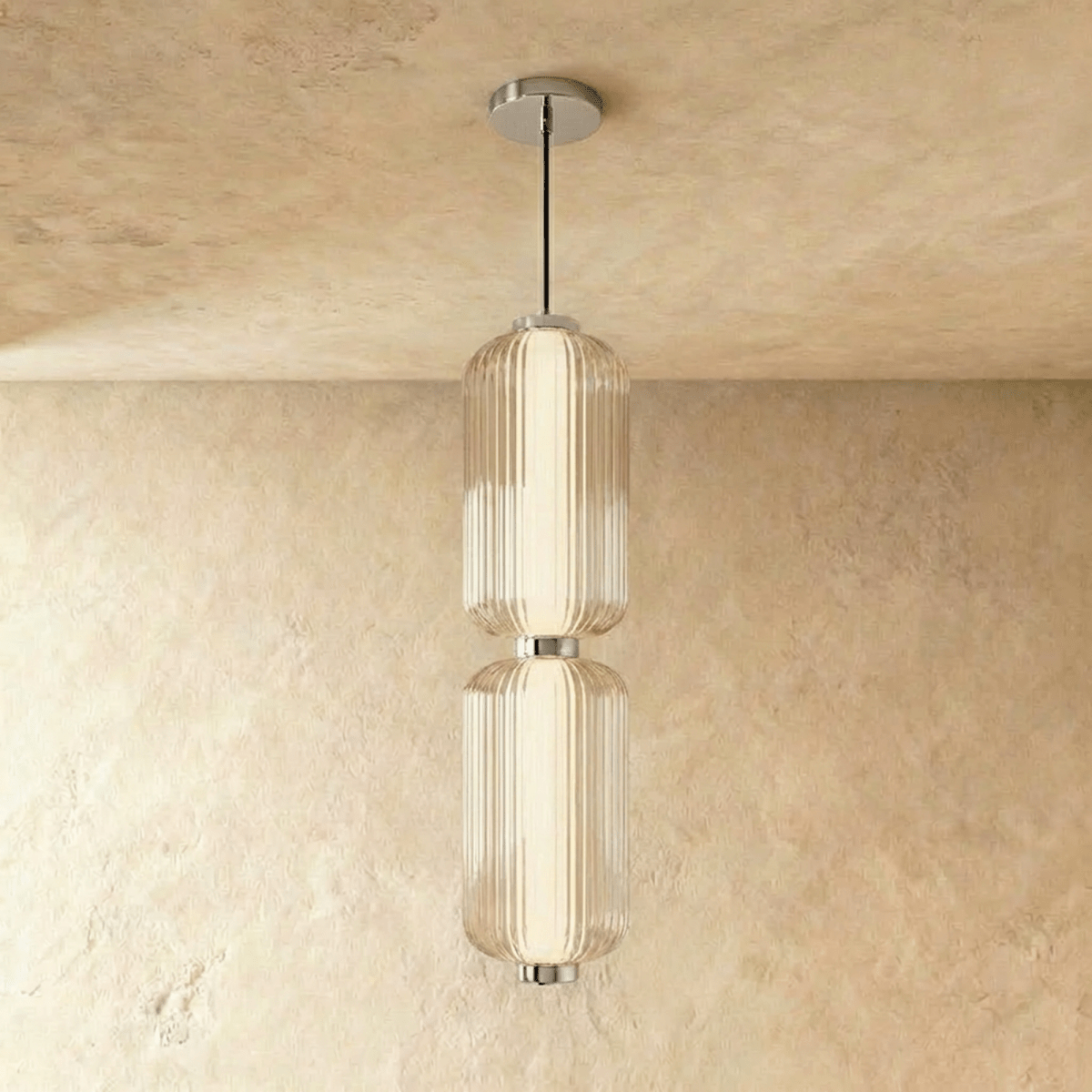 Clérachic two-tier ribbed glass pendant with chrome fittings and ceiling plate, hanging in a studio shot on a limewash wall.