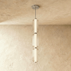 Clérachic three-tier ribbed glass pendant with chrome fittings, a tall glowing column hung in the studio on limewash.